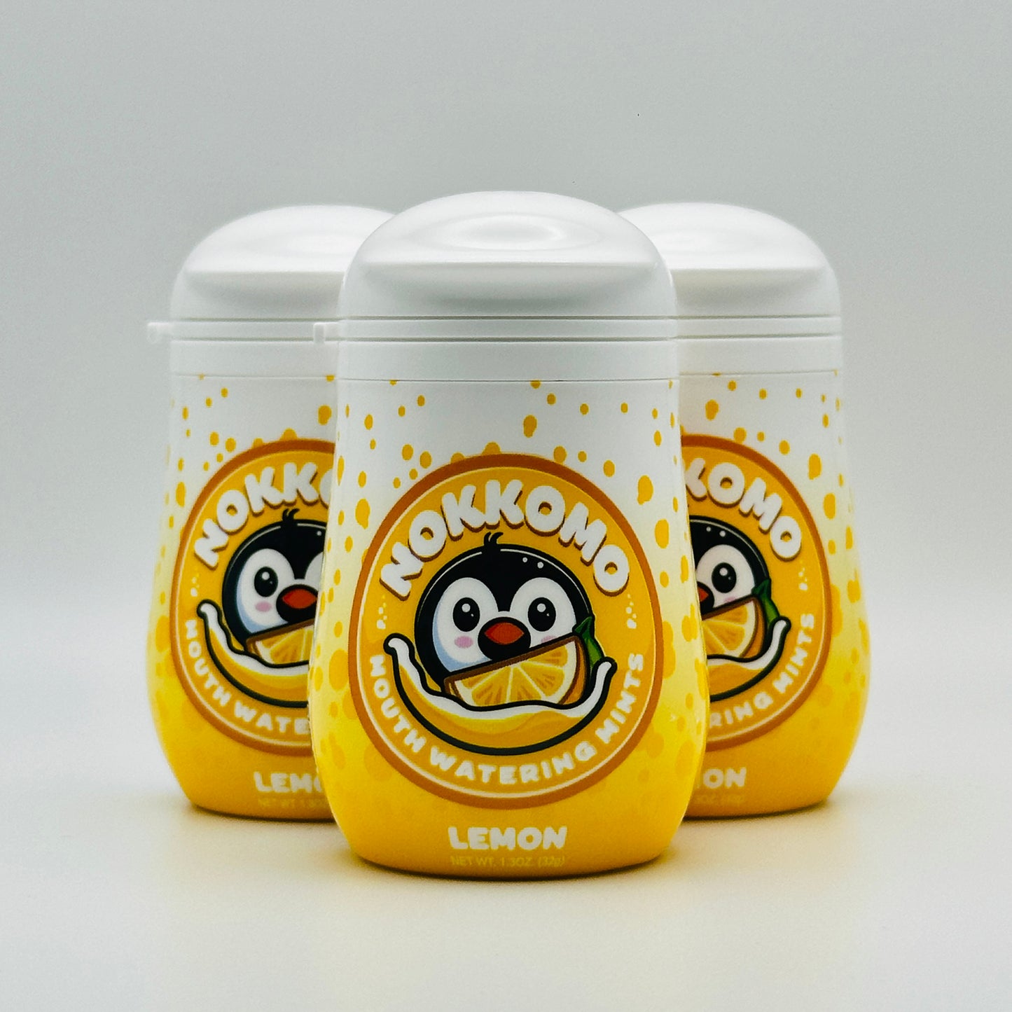Three bottles of Lemon flavored Nokkomo Mints for dry mouth relief and fresh breath in portable containers.