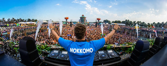 DJ at a musical festival with his arms up