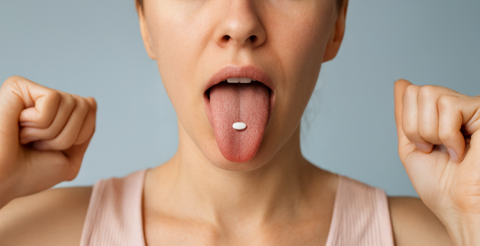 female with a mint on her tongue for dry mouth relief