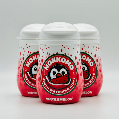 Three bottles of Watermelon flavored Nokkomo Mints for dry mouth relief and fresh breath in portable containers.